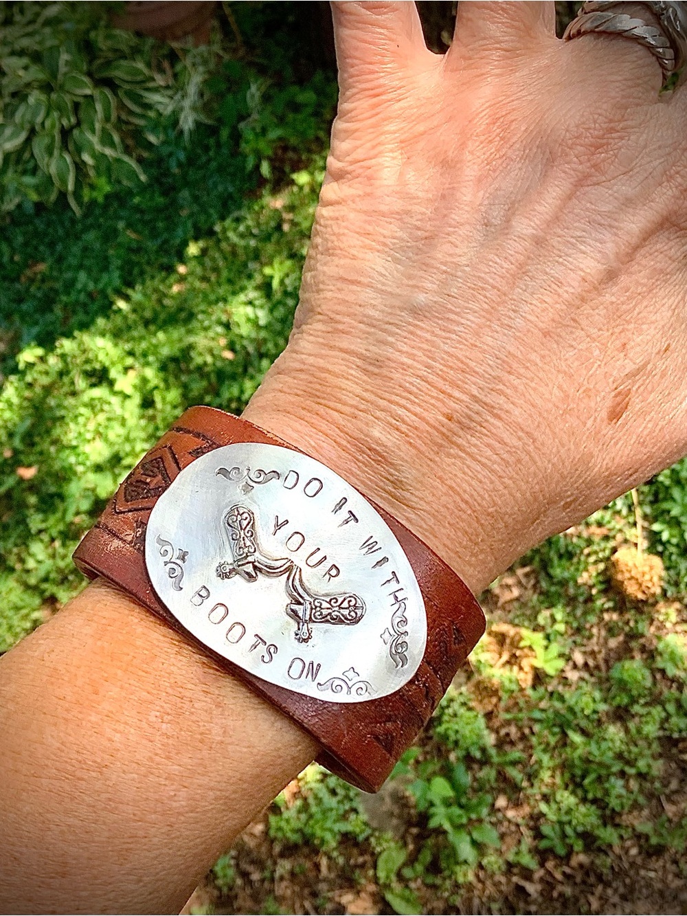 Leather cuff with 'Do It With Your Boots On' message, up to 6 3/4” wrist